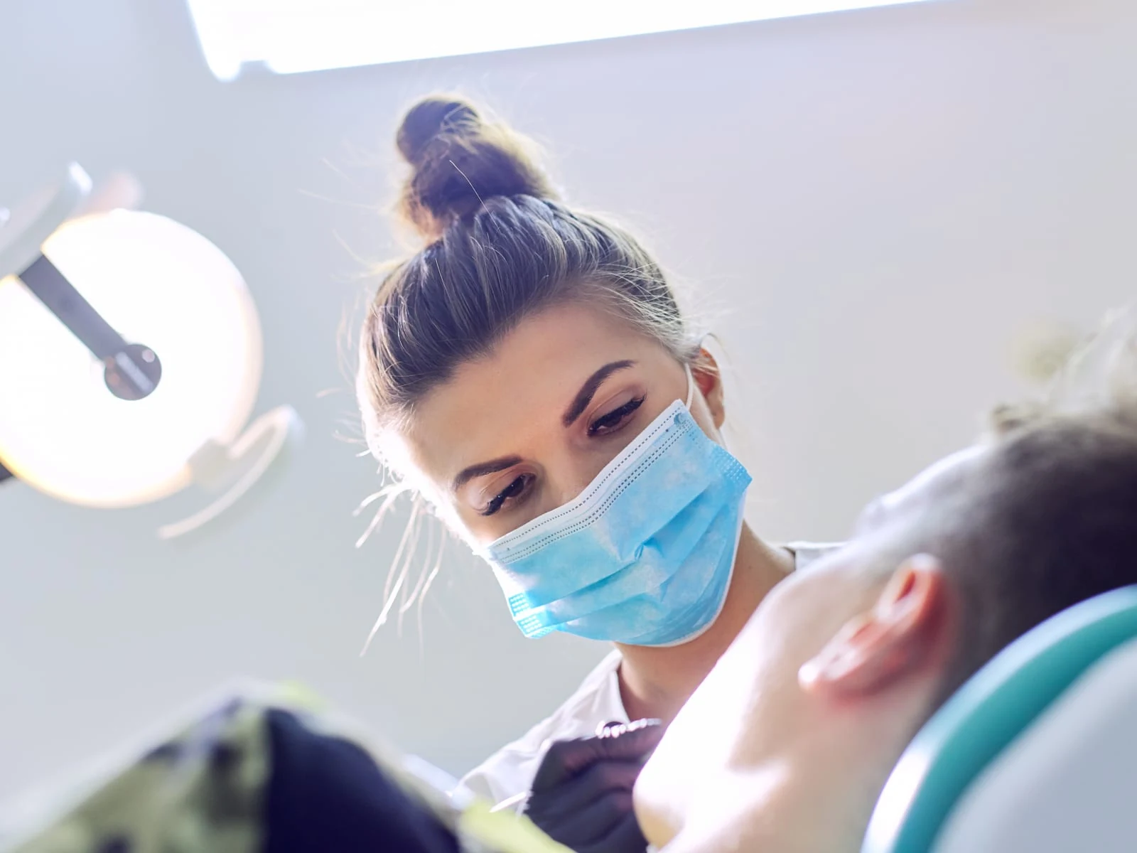 Etobicoke emergency dentist examining a patient during an urgent visit
